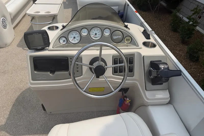 Slide: The Image of Steering console of a 2008 Crest 25 II XRS boat with gauges and controls. - 18