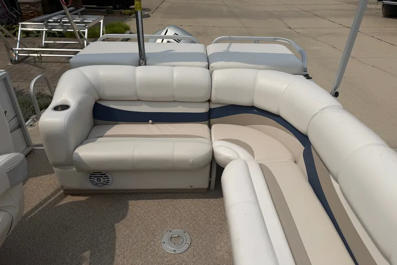 Slide: The Image of 2008 Crest 25 II XRS boat interior with white and blue cushioned seating. - 15