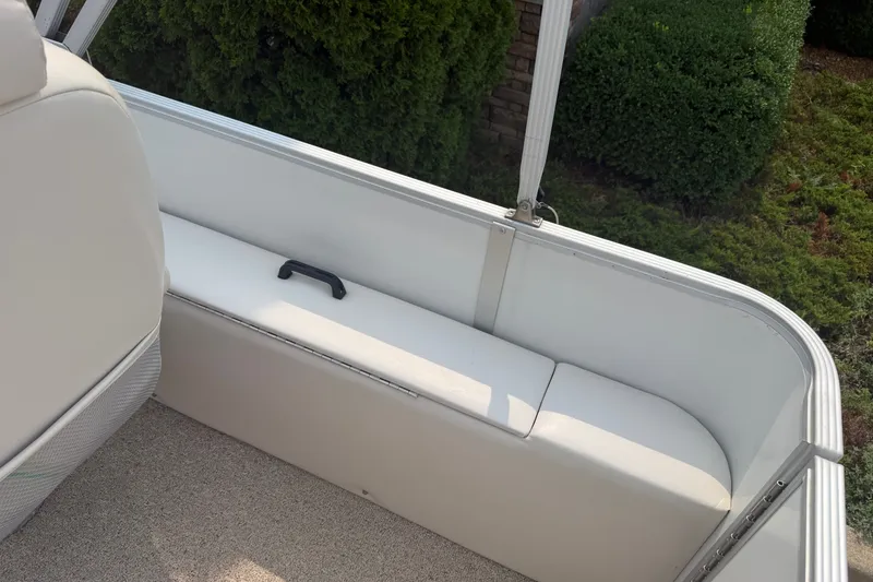Slide: The Image of Interior of a 2008 Crest 25 II XRS boat with white seating and greenery outside. - 24