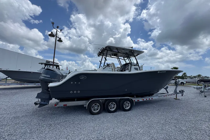 Slide: The Image of 2017 Sea Fox 328 Commander boat on trailer under cloudy sky. - 13