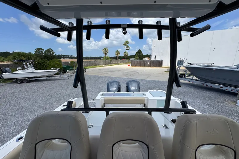 Slide: The Image of 2017 Sea Fox 328 Commander boat interior with dual engines, parked outdoors. - 34