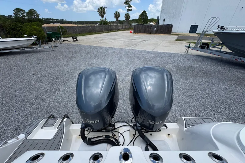 Slide: The Image of Twin Yamaha 300 engines on a 2017 Sea Fox 328 Commander boat, parked outdoors. - 50