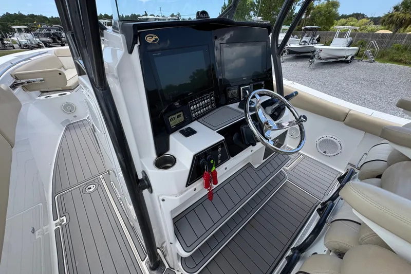 Slide: The Image of 2017 Sea Fox 328 Commander boat cockpit with dual screens and steering wheel. - 36