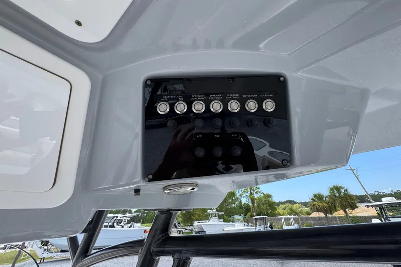 Slide: The Image of Control panel of a 2017 Sea Fox 328 Commander boat with various switches. - 41