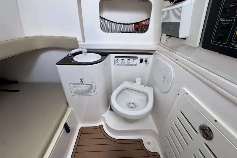 Slide: The Image of 2017 Sea Fox 328 Commander boat interior with compact marine toilet and sink. - 30
