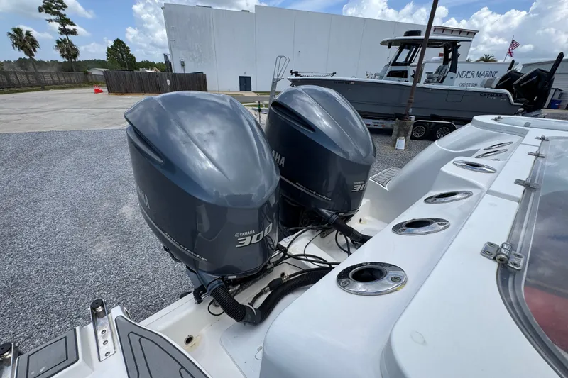 Slide: The Image of Twin Yamaha 300 engines on a 2017 Sea Fox 328 Commander boat, parked outdoors. - 52