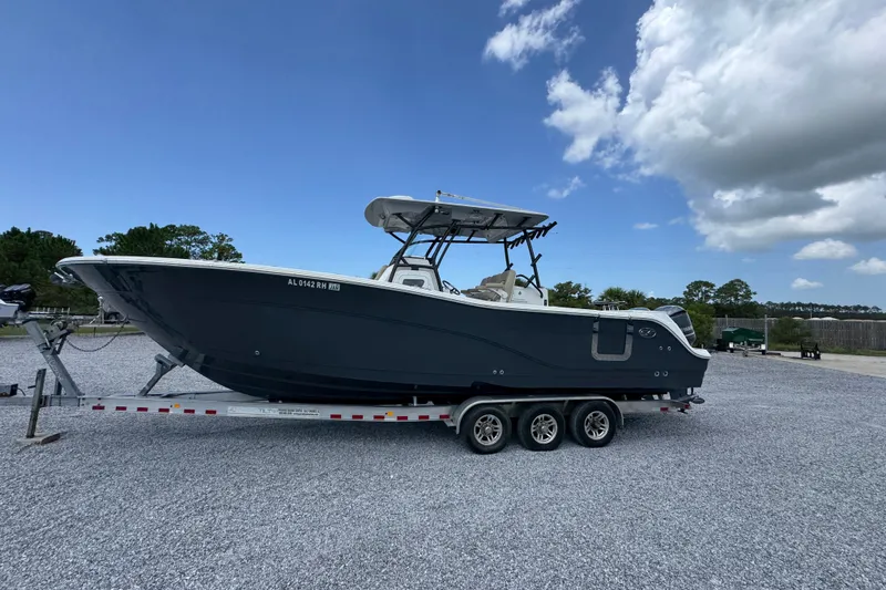Slide: The Image of 2017 Sea Fox 328 Commander boat on trailer under blue sky. - 2