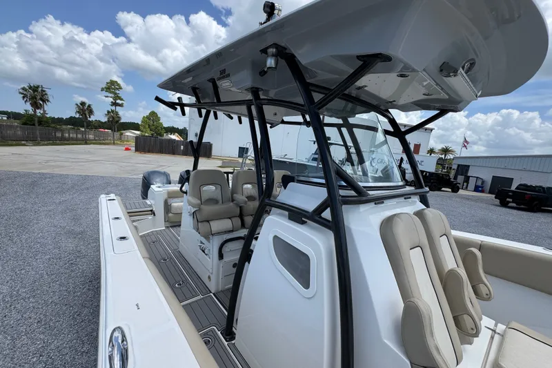 Slide: The Image of 2017 Sea Fox 328 Commander boat with seating and T-top under a cloudy sky. - 28