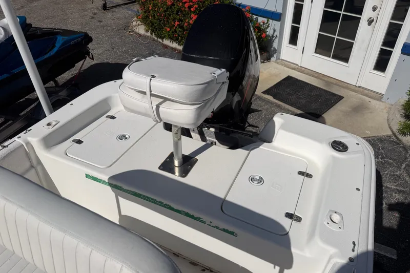 Slide: The Image of 2011 Carolina Skiff JVX18CC boat with white seating and storage compartments. - 8