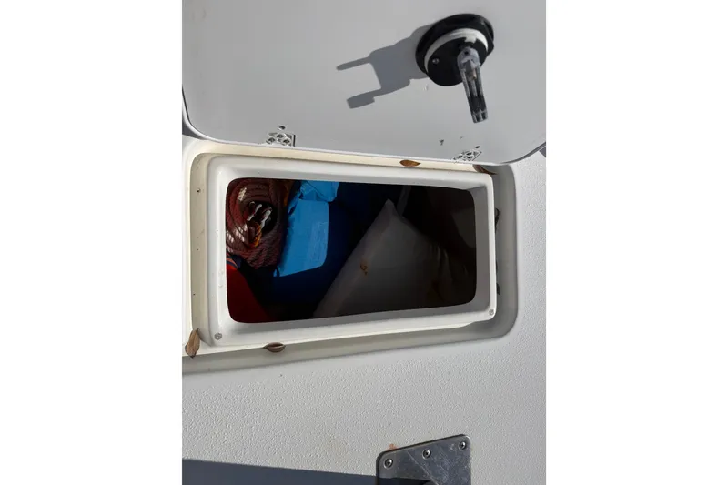 Slide: The Image of Open storage compartment on a 2011 Carolina Skiff JVX18CC boat. - 21