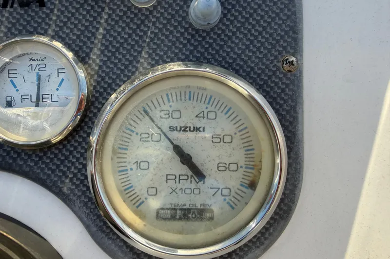 Slide: The Image of Close-up of 2011 Carolina Skiff JVX18CC dashboard with Suzuki RPM and fuel gauges. - 14