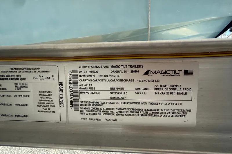 Slide: The Image of Label on Magic Tilt trailer for 2011 Carolina Skiff JVX18CC, showing specifications and safety standards. - 27