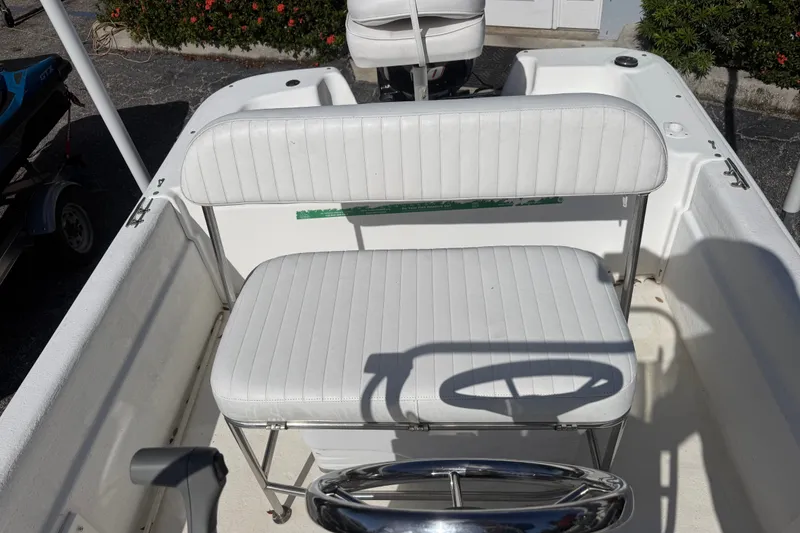 Slide: The Image of 2011 Carolina Skiff JVX18CC boat interior with white seating and steering wheel. - 11