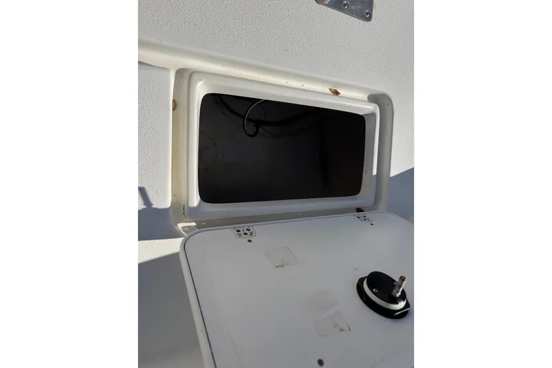 Slide: The Image of Open storage compartment on a 2011 Carolina Skiff JVX18CC boat. - 22