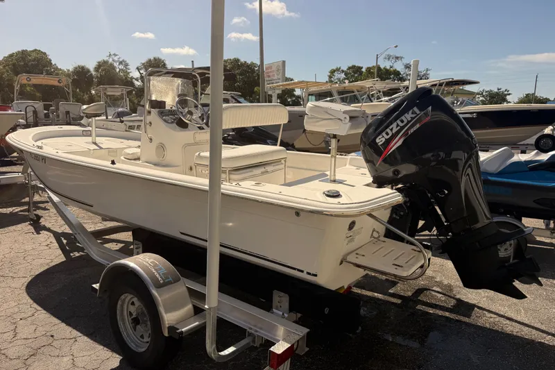 Slide: The Image of 2011 Carolina Skiff JVX18CC boat with Suzuki outboard motor on trailer. - 4