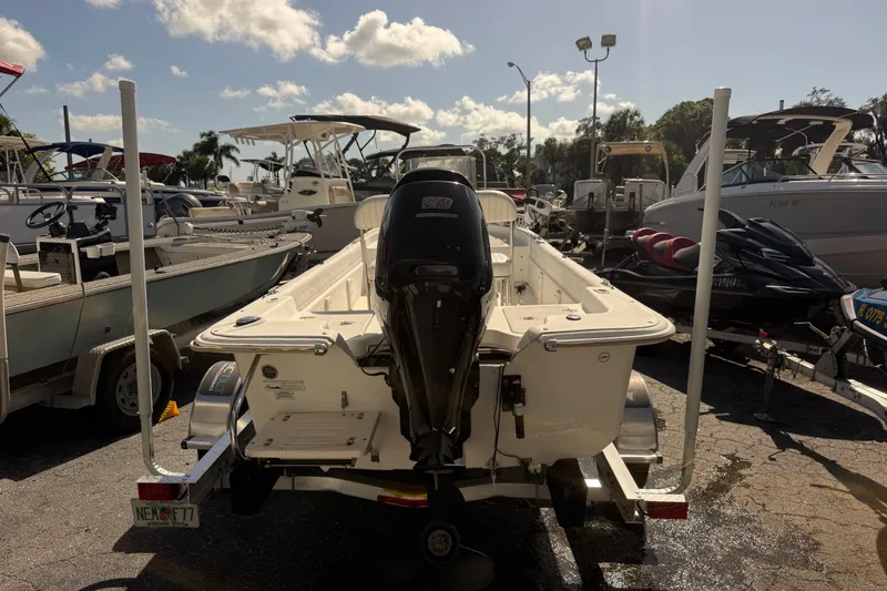 Slide: The Image of 2011 Carolina Skiff JVX18CC boat on trailer, parked among other boats and jet skis. - 3