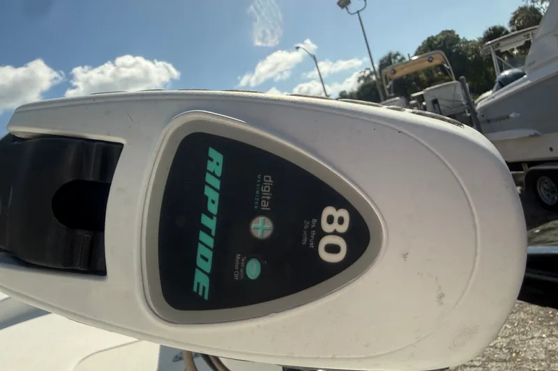 Slide: The Image of Minn Kota Riptide motor on 2011 Carolina Skiff JVX18CC under blue sky. - 24