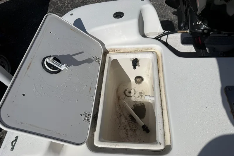 Slide: The Image of Open storage compartment on a 2011 Carolina Skiff JVX18CC boat. - 10