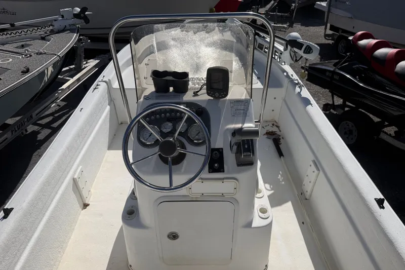 Slide: The Image of 2011 Carolina Skiff JVX18CC boat console with steering wheel and controls. - 13