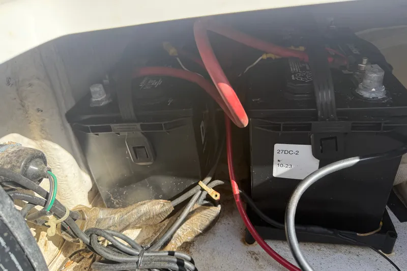 Slide: The Image of Batteries in a 2011 Carolina Skiff JVX18CC boat, with visible wiring connections. - 23