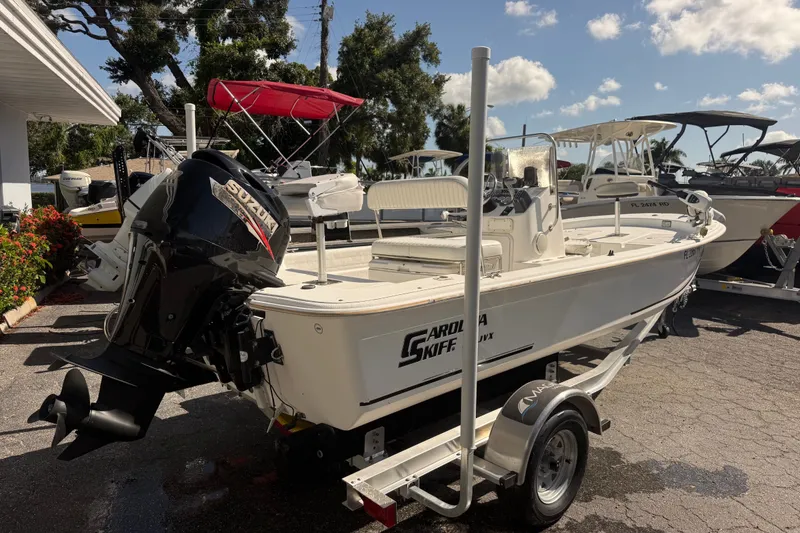 Slide: The Image of 2011 Carolina Skiff JVX18CC boat on trailer with Suzuki outboard motor. - 2