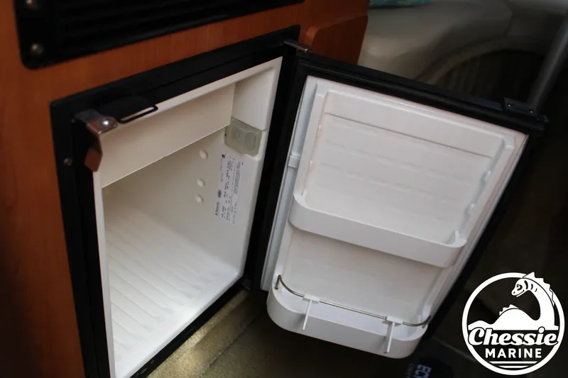 Slide: The Image of An open refrigerator inside a boat, with a Chessie Marine logo at the bottom right. - 39