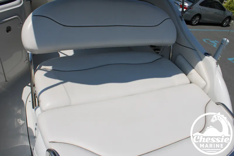 Slide: The Image of The image shows a white cushioned bench on a 2006 Crownline 250 boat. - 16