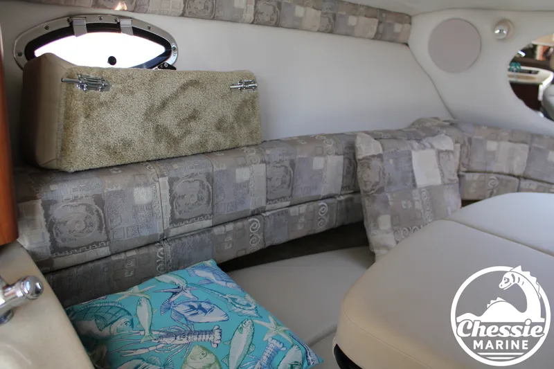 Slide: The Image of Interior of a 2006 Crownline 250 with cushioned seating and decorative pillows. - 47