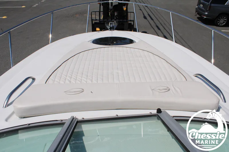 Slide: The Image of The image shows the foredeck of a 2006 Crownline 250 with a cushioned sunbathing area. - 28