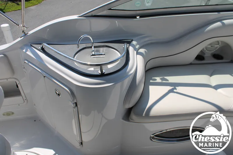 Slide: The Image of The image shows the cockpit of a 2006 Crownline 250 with a small sink and seating area. - 19