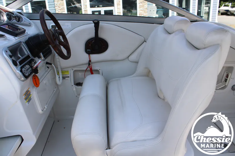 Slide: The Image of The image shows the cockpit of a 2006 Crownline 250 boat with white leather seats. - 22