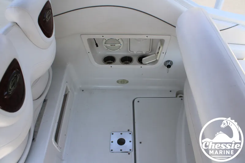 Slide: The Image of The image shows the interior of a 2006 Crownline 250 boat with white seating and cup holders. - 17