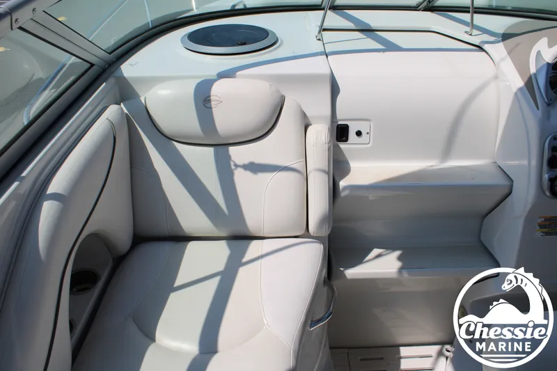 Slide: The Image of The image shows the interior of a 2006 Crownline 250 boat with white upholstery. - 21