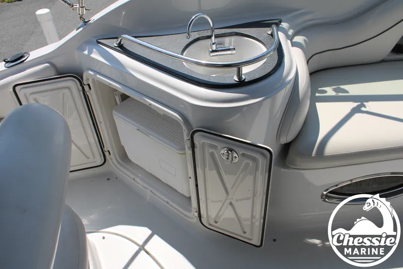 Slide: The Image of The image shows the cockpit of a 2006 Crownline 250 with a small sink and storage space. - 20