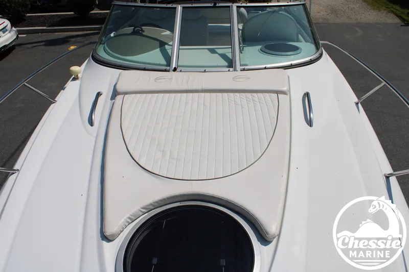 Slide: The Image of The image shows the foredeck of a 2006 Crownline 250 boat with a sun pad. - 26