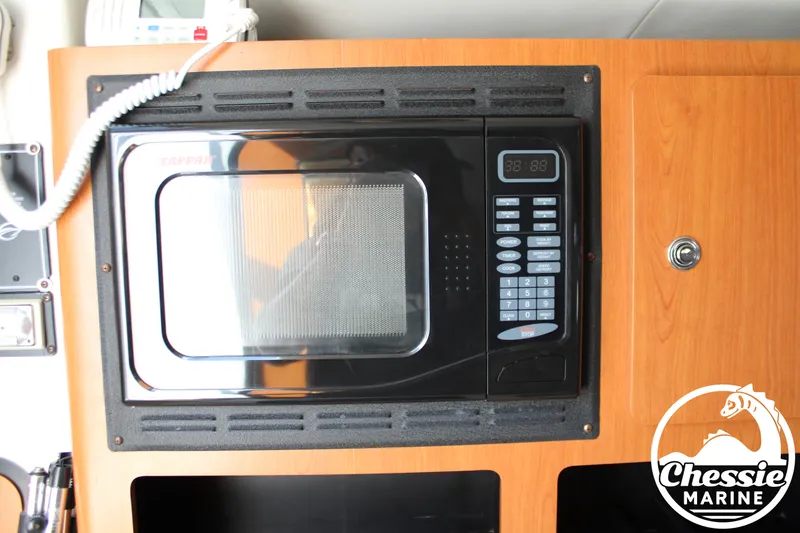 Slide: The Image of A microwave is built into a wooden cabinet. A Chessie Marine logo is visible at the bottom right. - 35