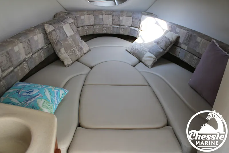 Slide: The Image of The image shows the interior of a 2006 Crownline 250 boat with cushioned seating. - 50