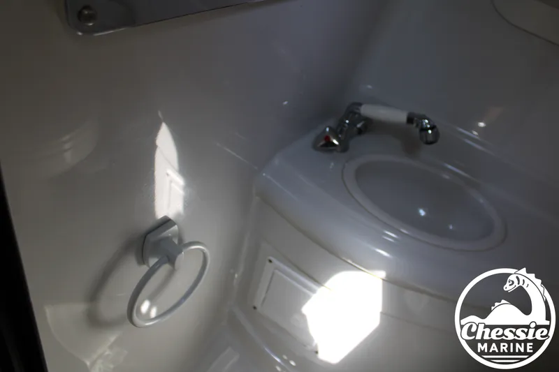 Slide: The Image of The image shows a boat bathroom with a sink and a towel ring. - 44