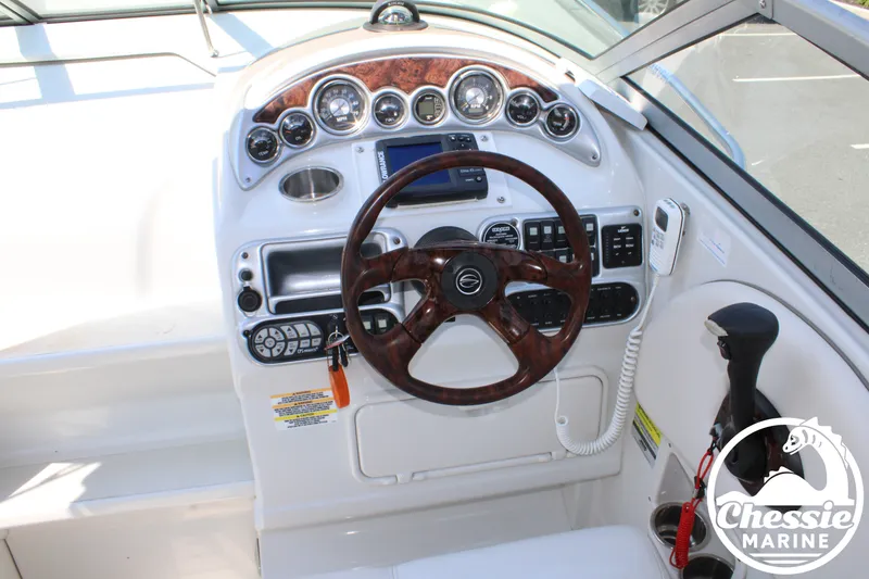 Slide: The Image of The image shows the cockpit of a 2006 Crownline 250 boat with a sleek wood steering wheel. - 23