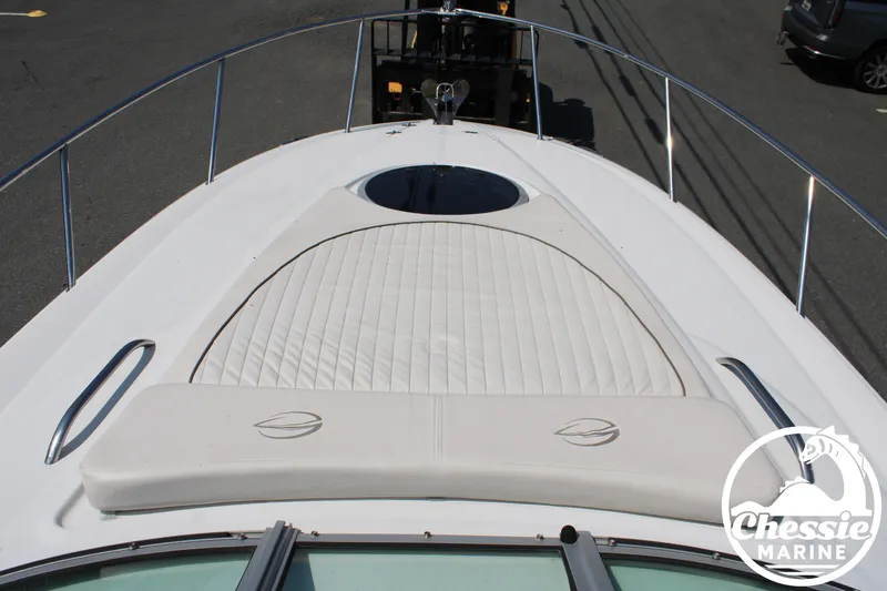 Slide: The Image of The image shows the foredeck of a 2006 Crownline 250 with a padded sunbathing area. - 25