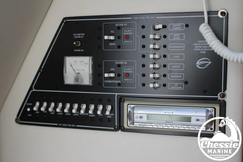 Slide: The Image of Electrical panel of a 2006 Crownline 250 with switches and a radio. - 34