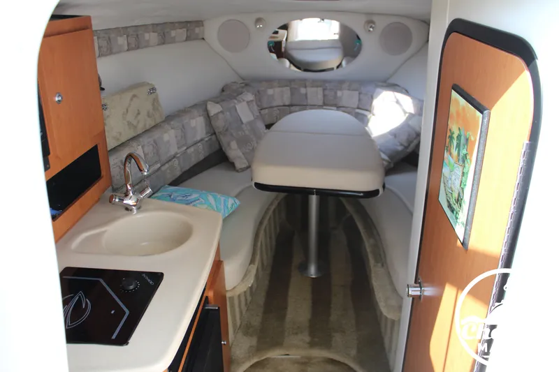 Slide: The Image of Interior of a 2006 Crownline 250 with cozy cabin, sink, and stove. - 33