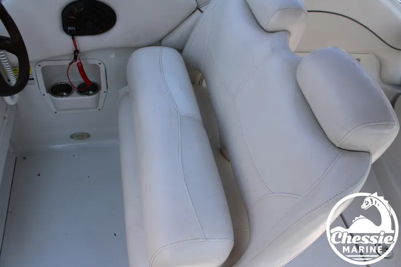 Slide: The Image of White cushioned bench seat in the cockpit of a 2006 Crownline 250 boat. - 31