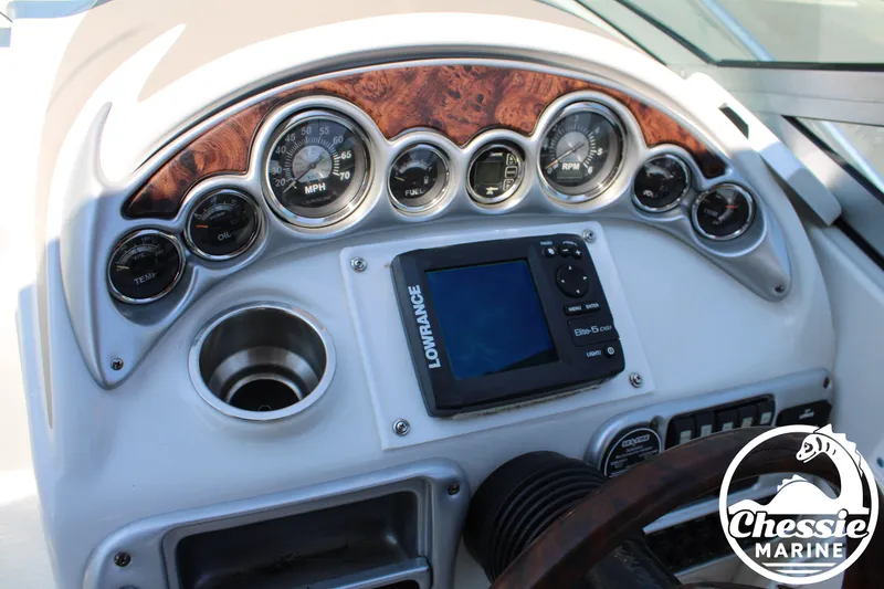 Slide: The Image of The dashboard of a 2006 Crownline 250 with gauges and a Lowrance display. - 29