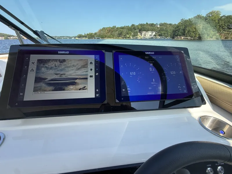 Slide: The Image of The Sea Ray SLX 310 dashboard features two large Simrad screens displaying navigation data. - 15