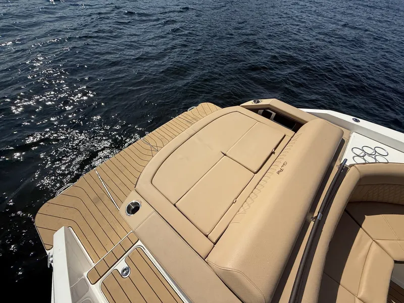 Slide: The Image of The image shows the deck of a 2027 Sea Ray SLX 310 boat with beige upholstery. - 7