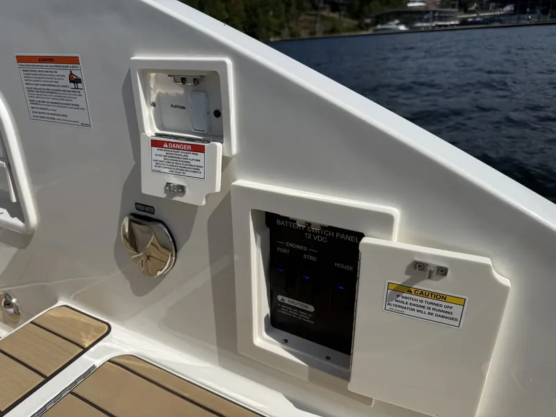 Slide: The Image of Battery switch panel and outlets on the 2027 Sea Ray SLX 310. - 13