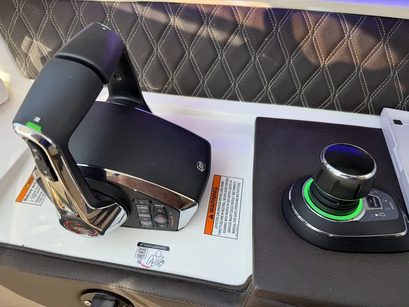 Slide: The Image of Close-up of a Sea Ray SLX 310 control console with modern controls. - 16