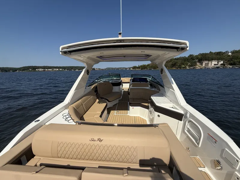 Slide: The Image of 2027 Sea Ray SLX 310 on calm water with a luxurious open deck. - 9