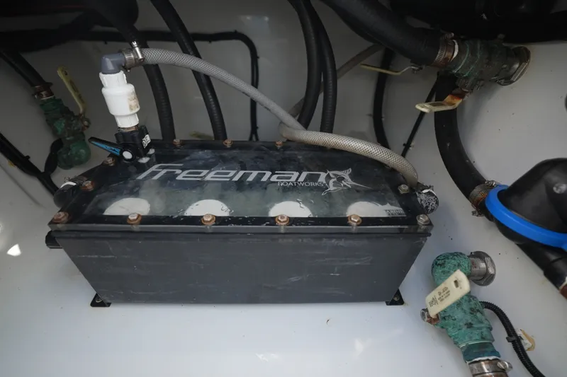 Slide: The Image of Engine compartment of a 2024 Freeman 42 boat, showcasing plumbing and components. - 48